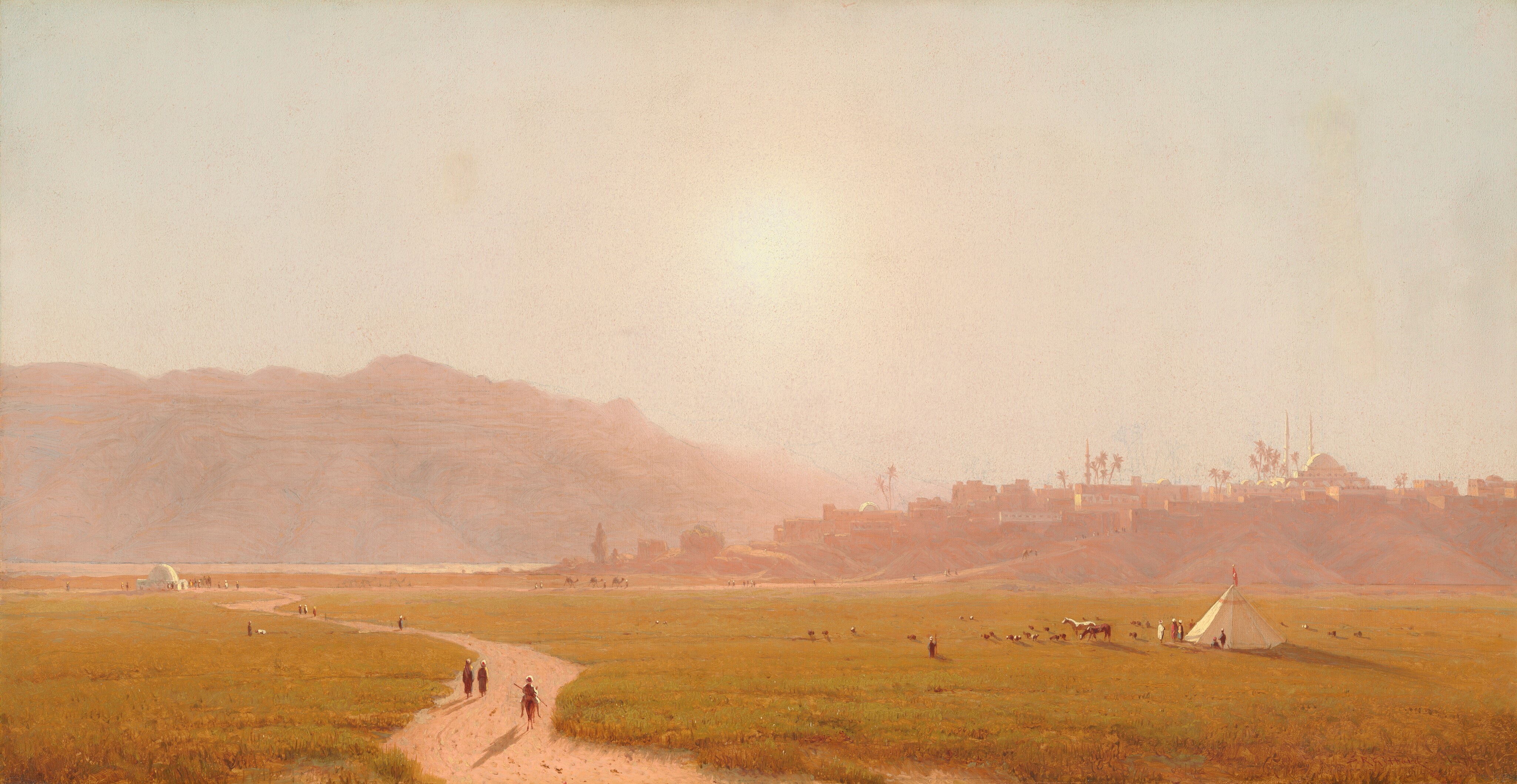 A molten, low-hanging sun dissolves the landscape into a shimmering veil of gold, casting the distant minarets and sweeping cliffs into a tender, hazy distance. Below, the luminous atmosphere breathes life into fields of vibrant green, where travelers, camels, and a pristine white stallion quietly gather in the glowing twilight.